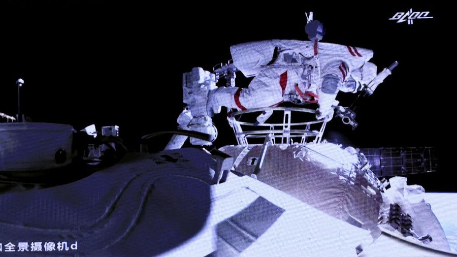 This photo released by Xinhua News Agency shows a screen at Beijing Aerospace Control Center showing astronaut Liu Boming stepping out of core module of the China's new space station in space on Sunday, July 4, 2021. Two astronauts made the first space walk on Sunday outside China's new orbital station to work on setting up a 15-meter (50-foot) long robotic arm. (Jin Liwang/Xinhua via AP)