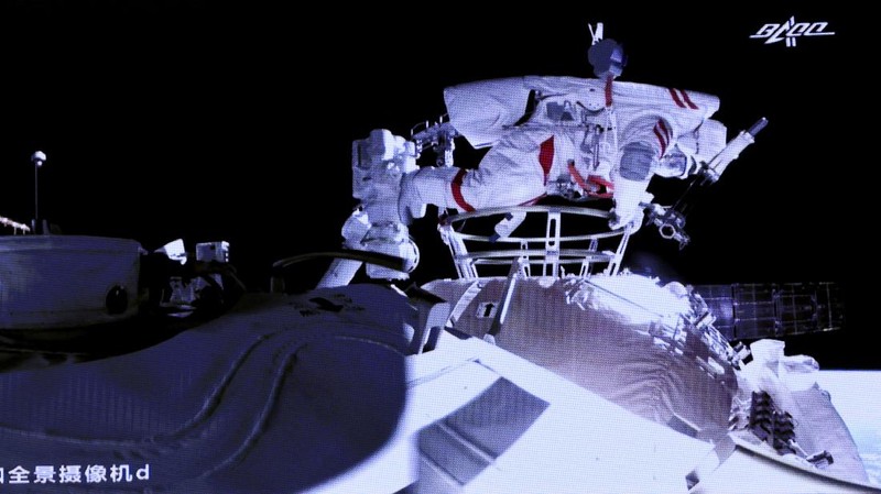 This photo released by Xinhua News Agency shows a screen at Beijing Aerospace Control Center showing astronaut Liu Boming stepping out of core module of the China's new space station in space on Sunday, July 4, 2021. Two astronauts made the first space walk on Sunday outside China's new orbital station to work on setting up a 15-meter (50-foot) long robotic arm. (Jin Liwang/Xinhua via AP)