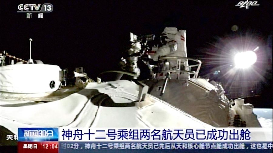 This photo released by Xinhua News Agency shows a screen at Beijing Aerospace Control Center showing astronaut Liu Boming stepping out of core module of the China's new space station in space on Sunday, July 4, 2021. Two astronauts made the first space walk on Sunday outside China's new orbital station to work on setting up a 15-meter (50-foot) long robotic arm. (Jin Liwang/Xinhua via AP)