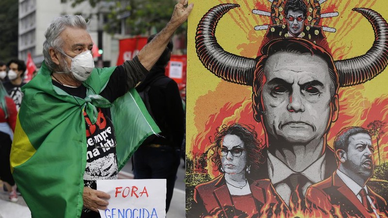 A giant cutout of Brazilian President Jair Bolsonaro towers over demonstrators marching along Paulista Avenue demanding Bolsonaro resign, in Sao Paulo, Brazil, Saturday, July 3, 2021. Activists called for nationwide demonstrations against Bolsonaro, gathering protestors to demand his impeachment amid allegations of potential corruption in the Health Ministry’s purchase of COVID-19 vaccines. (AP Photo/Nelson Antoine)