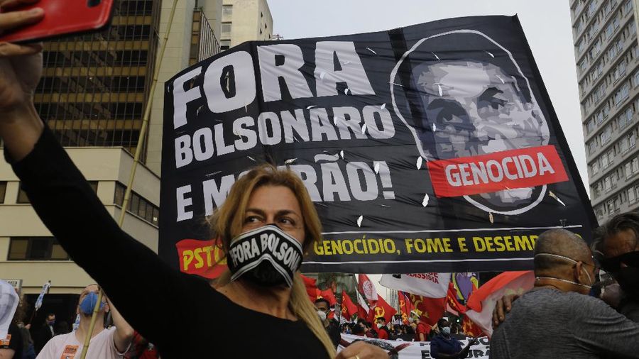 A giant cutout of Brazilian President Jair Bolsonaro towers over demonstrators marching along Paulista Avenue demanding Bolsonaro resign, in Sao Paulo, Brazil, Saturday, July 3, 2021. Activists called for nationwide demonstrations against Bolsonaro, gathering protestors to demand his impeachment amid allegations of potential corruption in the Health Ministry’s purchase of COVID-19 vaccines. (AP Photo/Nelson Antoine)