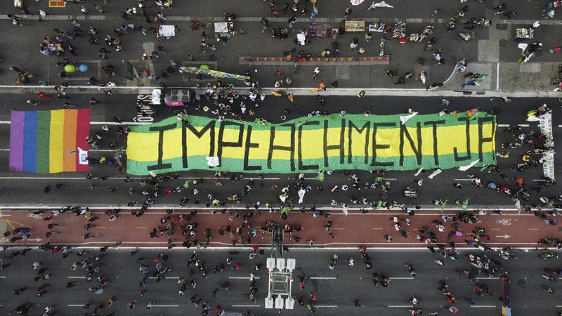 A giant cutout of Brazilian President Jair Bolsonaro towers over demonstrators marching along Paulista Avenue demanding Bolsonaro resign, in Sao Paulo, Brazil, Saturday, July 3, 2021. Activists called for nationwide demonstrations against Bolsonaro, gathering protestors to demand his impeachment amid allegations of potential corruption in the Health Ministry’s purchase of COVID-19 vaccines. (AP Photo/Nelson Antoine)