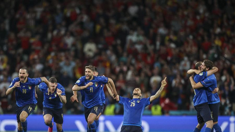 Italy's Federico Chiesa, right, scores the opening goal during the Euro 2020 soccer championship semifinal match between Italy and Spain at Wembley stadium in London, Tuesday, July 6, 2021. (Facundo Arrizabalaga/Pool Photo via AP)