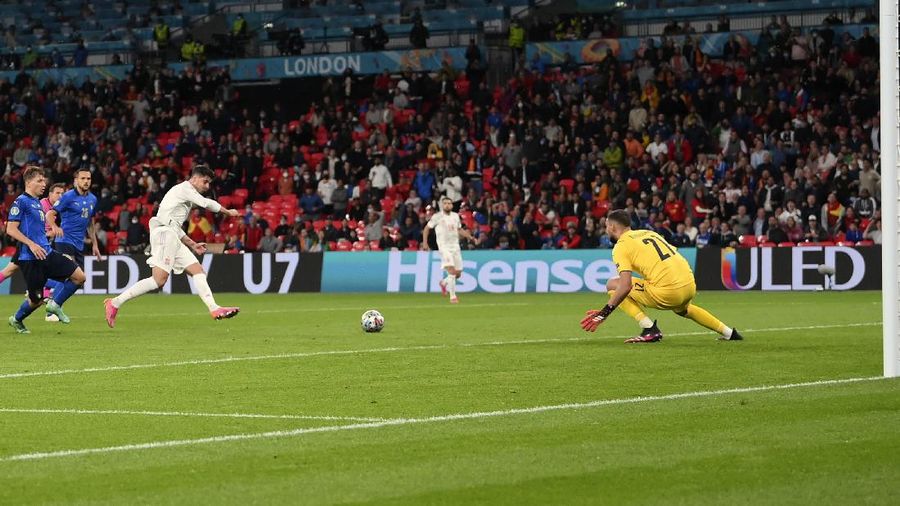 Italy's Federico Chiesa, right, scores the opening goal during the Euro 2020 soccer championship semifinal match between Italy and Spain at Wembley stadium in London, Tuesday, July 6, 2021. (Facundo Arrizabalaga/Pool Photo via AP)