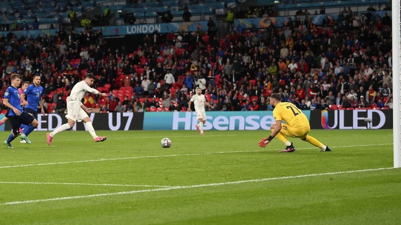 Italy's Federico Chiesa, right, scores the opening goal during the Euro 2020 soccer championship semifinal match between Italy and Spain at Wembley stadium in London, Tuesday, July 6, 2021. (Facundo Arrizabalaga/Pool Photo via AP)