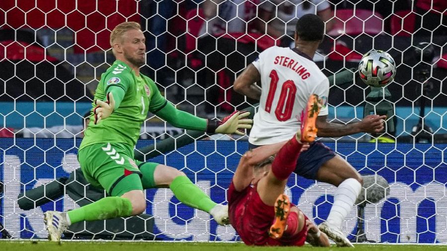 Denmark's Mikkel Damsgaard, left, scores his side's opening goal from a free kick during the Euro 2020 soccer semifinal match between England and Denmark at Wembley stadium in London, Wednesday, July 7, 2021. (Laurence Griffiths/Pool Photo via AP)