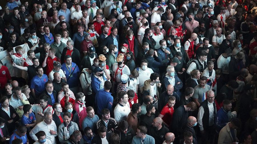 Fans celebrate outside Wembley Stadium after England qualified for the Euro 2020 final where they will face Italy on Sunday, following the Euro 2020 soccer championship semifinal match between England and Denmark, in London, England, Wednesday, July 7, 2021. (Zac Goodwin/PA via AP)