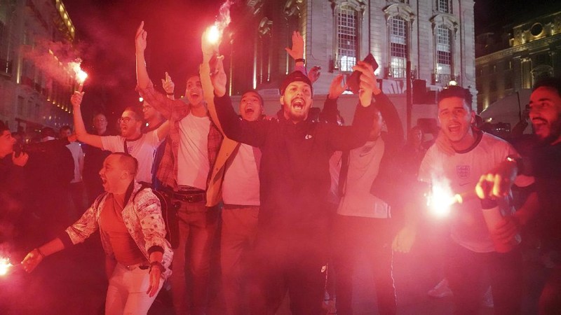 Fans celebrate outside Wembley Stadium after England qualified for the Euro 2020 final where they will face Italy on Sunday, following the Euro 2020 soccer championship semifinal match between England and Denmark, in London, England, Wednesday, July 7, 2021. (Zac Goodwin/PA via AP)