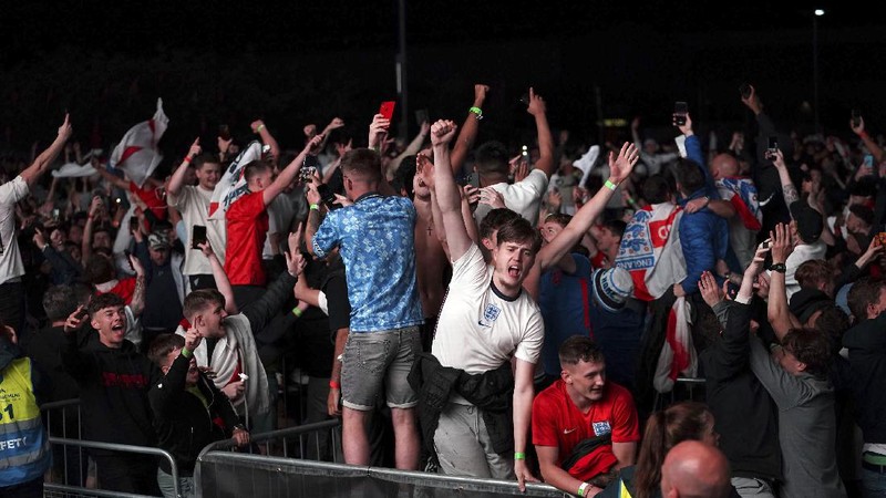 Fans celebrate outside Wembley Stadium after England qualified for the Euro 2020 final where they will face Italy on Sunday, following the Euro 2020 soccer championship semifinal match between England and Denmark, in London, England, Wednesday, July 7, 2021. (Zac Goodwin/PA via AP)