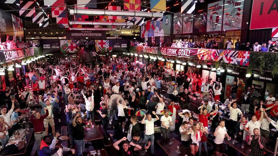 Fans celebrate outside Wembley Stadium after England qualified for the Euro 2020 final where they will face Italy on Sunday, following the Euro 2020 soccer championship semifinal match between England and Denmark, in London, England, Wednesday, July 7, 2021. (Zac Goodwin/PA via AP)