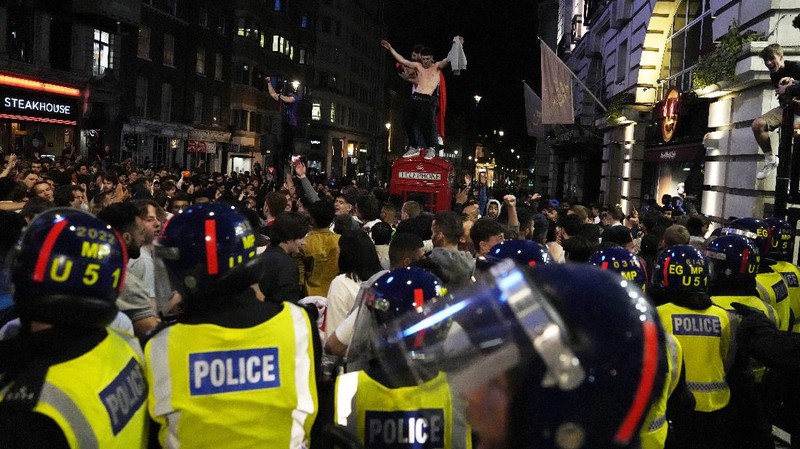 Fans celebrate outside Wembley Stadium after England qualified for the Euro 2020 final where they will face Italy on Sunday, following the Euro 2020 soccer championship semifinal match between England and Denmark, in London, England, Wednesday, July 7, 2021. (Zac Goodwin/PA via AP)