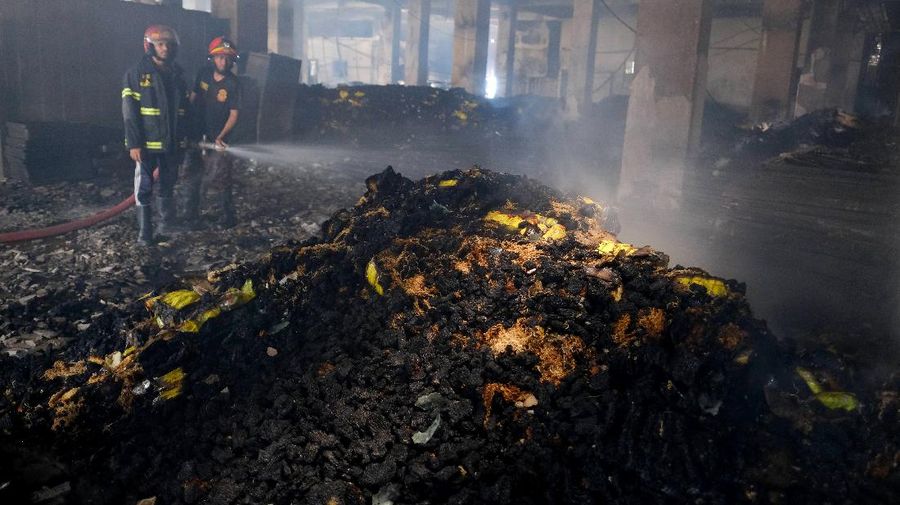 Firefighters work to douse a fire at a food and beverage factory in Rupganj, outside Dhaka, Bangladesh, Friday, July 9, 2021. At least 52 people died in a huge blaze that engulfed a food and beverage factory outside Bangladesh's capital, fire officials said Friday, in the latest industrial disaster to hit the South Asian nation. (AP Photo/Mahmud Hossain Opu)