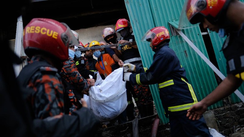 Firefighters work to douse a fire at a food and beverage factory in Rupganj, outside Dhaka, Bangladesh, Friday, July 9, 2021. At least 52 people died in a huge blaze that engulfed a food and beverage factory outside Bangladesh's capital, fire officials said Friday, in the latest industrial disaster to hit the South Asian nation. (AP Photo/Mahmud Hossain Opu)