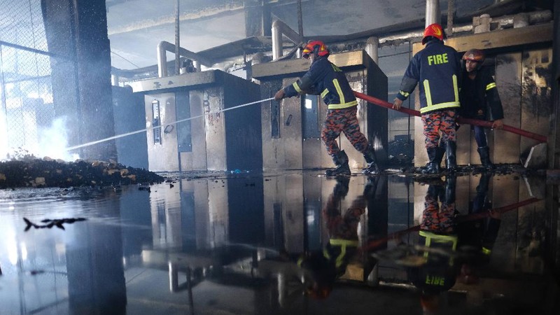 Firefighters work to douse a fire at a food and beverage factory in Rupganj, outside Dhaka, Bangladesh, Friday, July 9, 2021. At least 52 people died in a huge blaze that engulfed a food and beverage factory outside Bangladesh's capital, fire officials said Friday, in the latest industrial disaster to hit the South Asian nation. (AP Photo/Mahmud Hossain Opu)