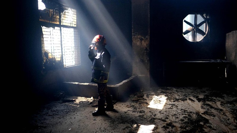 Firefighters work to douse a fire at a food and beverage factory in Rupganj, outside Dhaka, Bangladesh, Friday, July 9, 2021. At least 52 people died in a huge blaze that engulfed a food and beverage factory outside Bangladesh's capital, fire officials said Friday, in the latest industrial disaster to hit the South Asian nation. (AP Photo/Mahmud Hossain Opu)