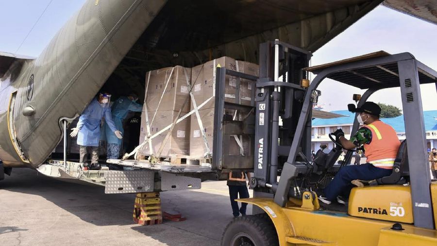 In this photo released by Indonesian Armed Forces, a military personnel uses a forklift to unload relief goods from a Singaporean Air Force cargo plane at Halim Perdanakusuma Airbase in Jakarta, Indonesia, Friday, July 9, 2021. The world's fourth most populous country is running out of oxygen as it endures a devastating wave of coronavirus cases and the government is seeking emergency supplies from other countries, including Singapore and China. (Indonesian Armed Forces via AP)