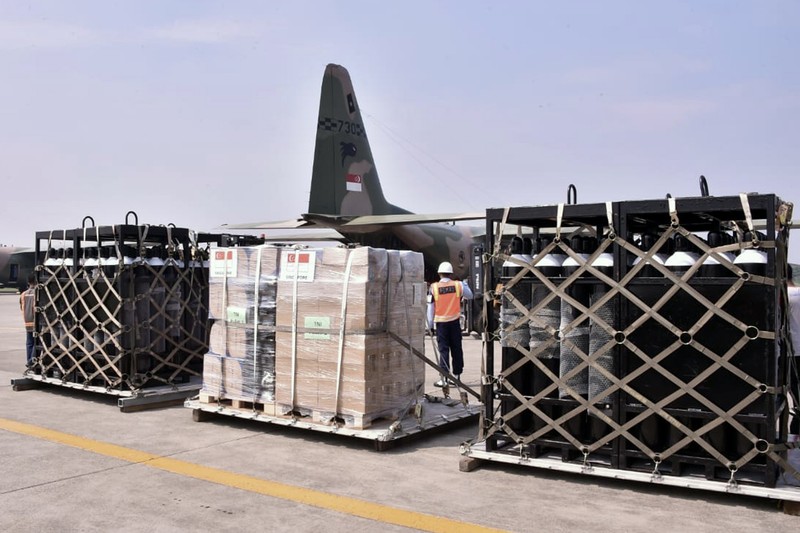 Virus Outbreak In this photo released by Indonesian Armed Forces, a military personnel uses a forklift to unload relief goods from a Singaporean Air Force cargo plane at Halim Perdanakusuma Airbase in Jakarta, Indonesia, Friday, July 9, 2021. The world's fourth most populous country is running out of oxygen as it endures a devastating wave of coronavirus cases and the government is seeking emergency supplies from other countries, including Singapore and China. (Indonesian Armed Forces via AP)