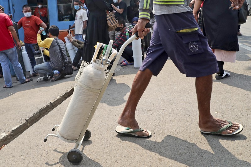 Virus Outbreak In this photo released by Indonesian Armed Forces, a military personnel uses a forklift to unload relief goods from a Singaporean Air Force cargo plane at Halim Perdanakusuma Airbase in Jakarta, Indonesia, Friday, July 9, 2021. The world's fourth most populous country is running out of oxygen as it endures a devastating wave of coronavirus cases and the government is seeking emergency supplies from other countries, including Singapore and China. (Indonesian Armed Forces via AP)