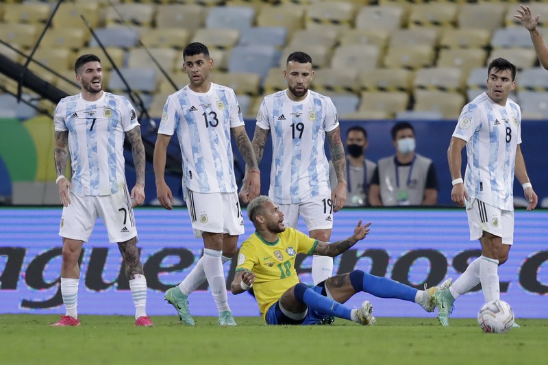 Brazil Argentina Copa America Soccer Argentina's Lionel Messi holds the trophy as he celebrates with the team after beating 1-0 Brazil in the Copa America final soccer match at the Maracana stadium in Rio de Janeiro, Brazil, Saturday, July 10, 2021. (AP Photo/Andre Penner)