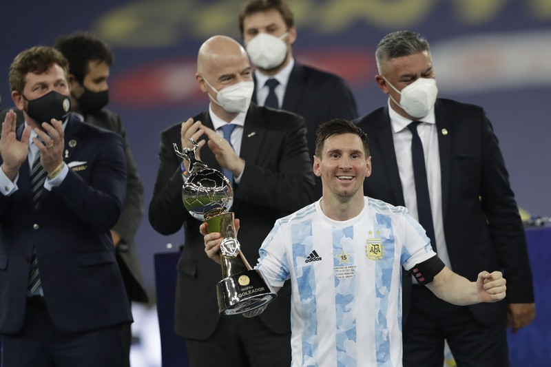 Brazil Argentina Copa America Soccer Argentina's Lionel Messi holds the trophy as he celebrates with the team after beating 1-0 Brazil in the Copa America final soccer match at the Maracana stadium in Rio de Janeiro, Brazil, Saturday, July 10, 2021. (AP Photo/Andre Penner)