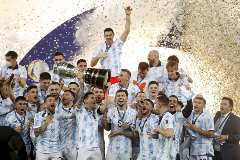Brazil Argentina Copa America Soccer Argentina's Lionel Messi holds the trophy as he celebrates with the team after beating 1-0 Brazil in the Copa America final soccer match at the Maracana stadium in Rio de Janeiro, Brazil, Saturday, July 10, 2021. (AP Photo/Andre Penner)