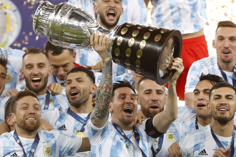 Brazil Argentina Copa America Soccer Argentina's Lionel Messi holds the trophy as he celebrates with the team after beating 1-0 Brazil in the Copa America final soccer match at the Maracana stadium in Rio de Janeiro, Brazil, Saturday, July 10, 2021. (AP Photo/Andre Penner)