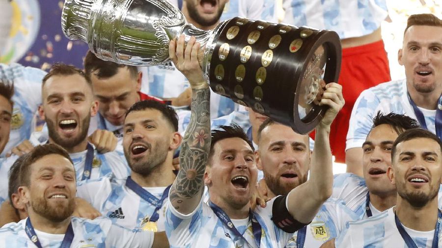 Argentina's Lionel Messi holds the trophy as he celebrates with the team after beating 1-0 Brazil in the Copa America final soccer match at the Maracana stadium in Rio de Janeiro, Brazil, Saturday, July 10, 2021. (AP Photo/Andre Penner)