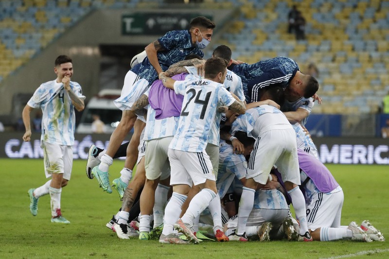 Brazil Argentina Copa America Soccer Argentina's Lionel Messi holds the trophy as he celebrates with the team after beating 1-0 Brazil in the Copa America final soccer match at the Maracana stadium in Rio de Janeiro, Brazil, Saturday, July 10, 2021. (AP Photo/Andre Penner)
