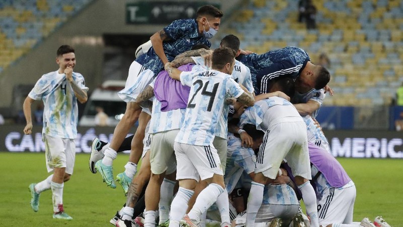 Argentina's Lionel Messi holds the trophy as he celebrates with the team after beating 1-0 Brazil in the Copa America final soccer match at the Maracana stadium in Rio de Janeiro, Brazil, Saturday, July 10, 2021. (AP Photo/Andre Penner)