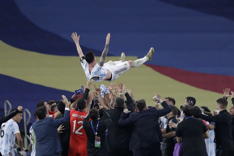 Brazil Argentina Copa America Soccer Argentina's Lionel Messi holds the trophy as he celebrates with the team after beating 1-0 Brazil in the Copa America final soccer match at the Maracana stadium in Rio de Janeiro, Brazil, Saturday, July 10, 2021. (AP Photo/Andre Penner)