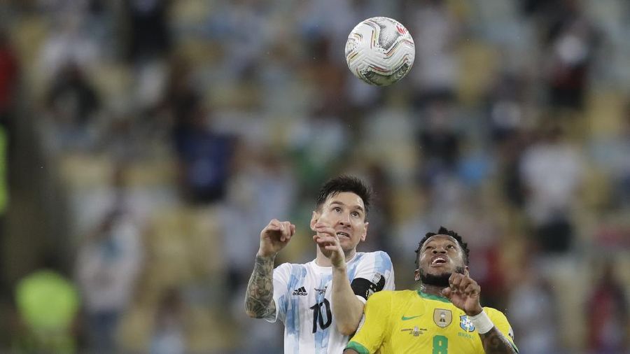 Argentina's Lionel Messi holds the trophy as he celebrates with the team after beating 1-0 Brazil in the Copa America final soccer match at the Maracana stadium in Rio de Janeiro, Brazil, Saturday, July 10, 2021. (AP Photo/Andre Penner)