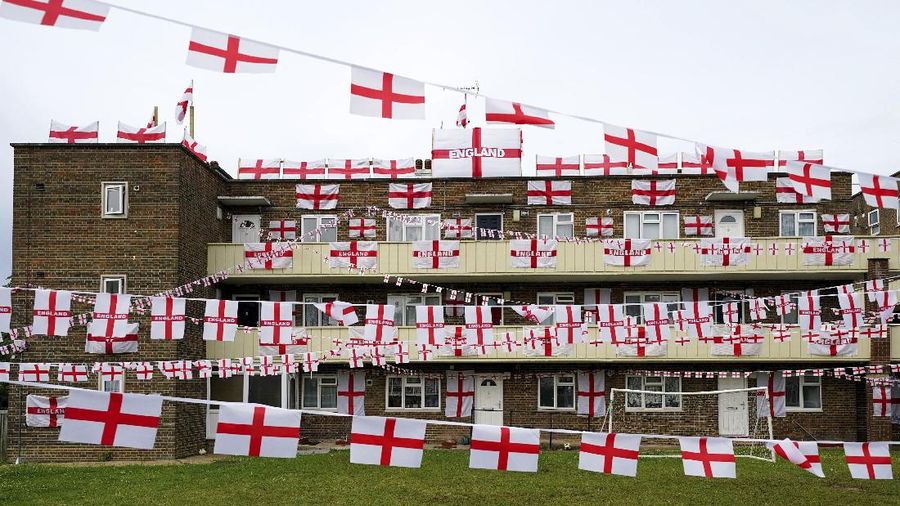 England flags are displayed from Towfield Court in Feltham, England, ahead of the final match of Euro 2020 against Italy on Sunday. (Jonathan Brady/PA via AP)(/PA via AP)