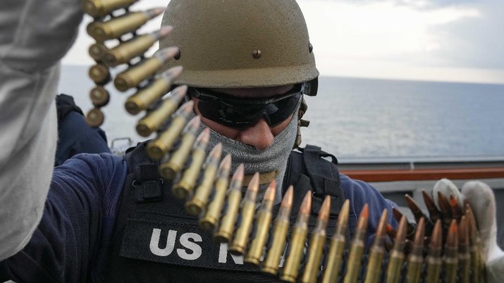 CAPTION CORRECTS DATE US Navy sailor of destroyer USS Ross Nicholas Schwab from Breinero, Minnesota, prepares his machine gun during Sea Breeze 2021 maneuvers, in the Black Sea, Wednesday, July 7, 2021.  Ukraine and NATO have conducted Black Sea drills involving dozens of warships in a two-week show of their strong defense ties and capability following a confrontation between Russia's military forces and a British destroyer off Crimea last month. (AP Photo/Efrem Lukatsky)