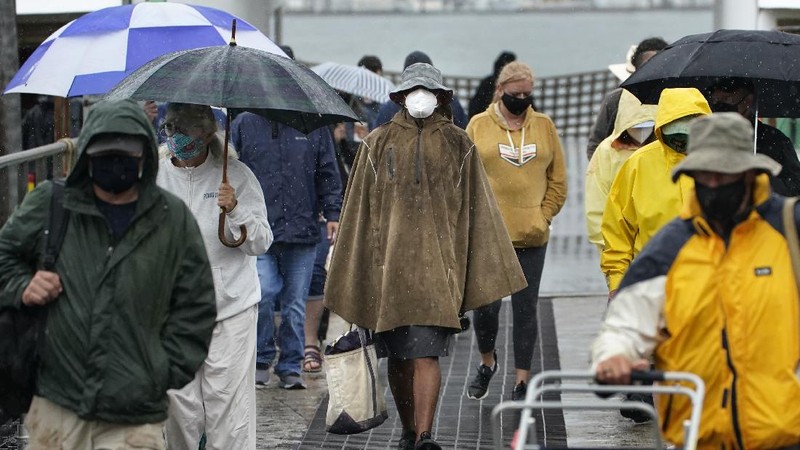 A pedestrian uses an umbrella to shield himself during a downpour from Tropical Storm Elsa, Friday, July 9, 2021, in Portland, Maine. Elsa is the earliest fifth-named storm on record, said Brian McNoldy, a hurricane researcher at the University of Miami. (AP Photo/Robert F. Bukaty)