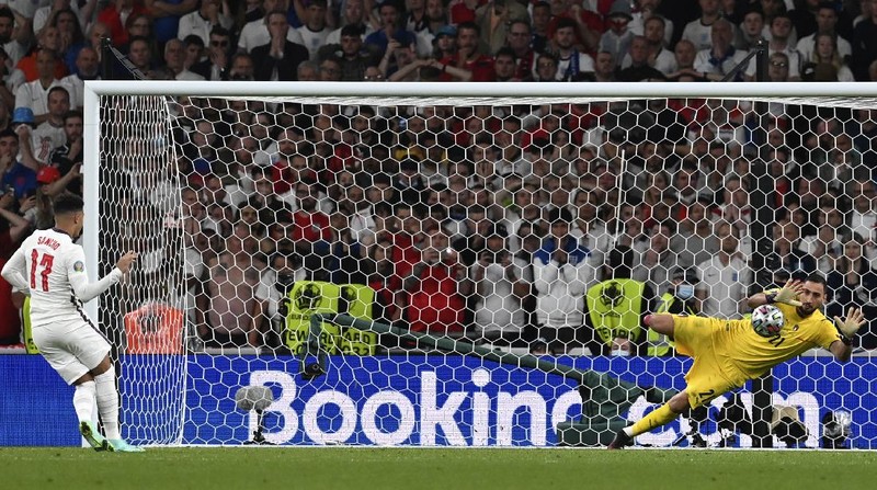 Italy's team celebrates with the trophy on the podium after winning the Euro 2020 soccer championship final between England and Italy at Wembley stadium in London, Sunday, July 11, 2021. (Michael Regan/Pool via AP)