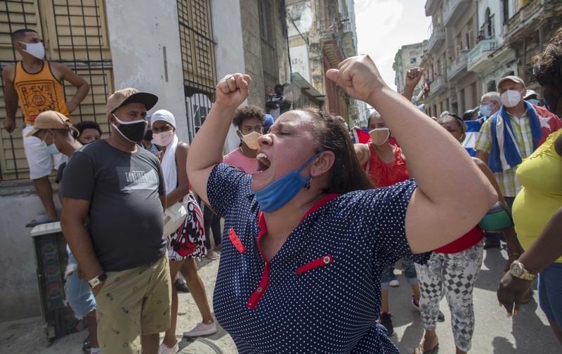 Backers of the government march in Havana, Cuba, Sunday, July 11, 2021. Hundreds of supporters of the government took to the streets while hundreds more protested against ongoing food shortages and high prices of foodstuffs. (AP Photo/Eliana Aponte)