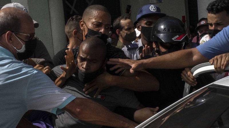Backers of the government march in Havana, Cuba, Sunday, July 11, 2021. Hundreds of supporters of the government took to the streets while hundreds more protested against ongoing food shortages and high prices of foodstuffs. (AP Photo/Eliana Aponte)