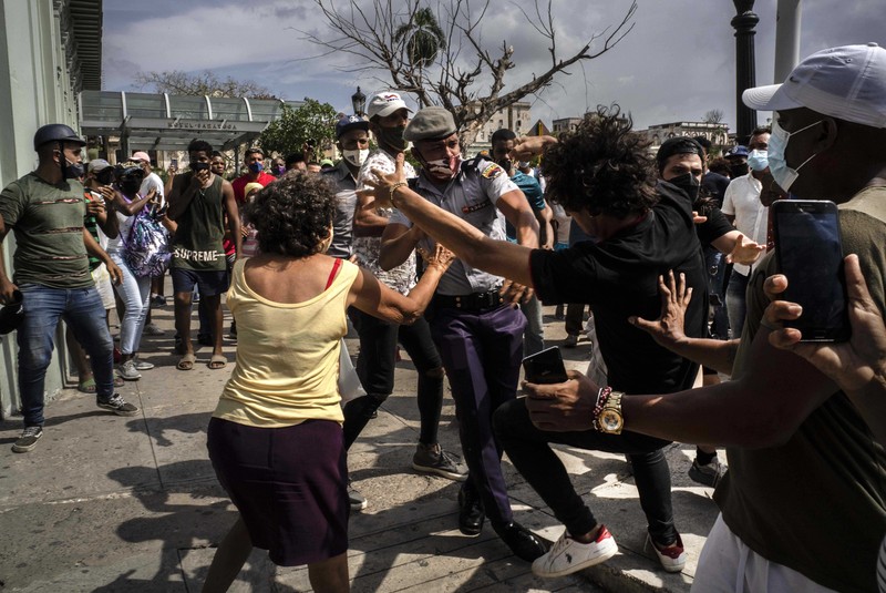 Backers of the government march in Havana, Cuba, Sunday, July 11, 2021. Hundreds of supporters of the government took to the streets while hundreds more protested against ongoing food shortages and high prices of foodstuffs. (AP Photo/Eliana Aponte)