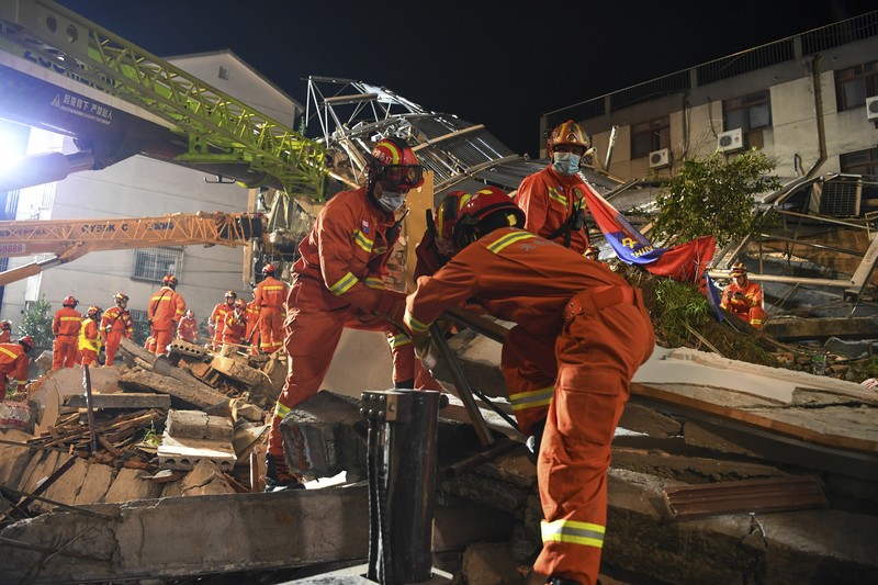 China Hotel Collapse In this photo released by Xinhua News Agency, rescuers prepare equipment as they search for survivors at a collapsed hotel in Suzhou in eastern China's Jiangsu Province on Monday, July 12, 2021. The hotel building collapsed Monday afternoon. (Li Bo/Xinhua via AP)