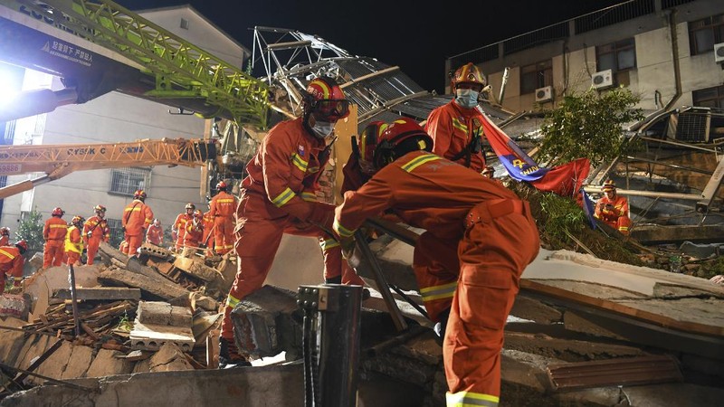 In this photo released by Xinhua News Agency, rescuers prepare equipment as they search for survivors at a collapsed hotel in Suzhou in eastern China's Jiangsu Province on Monday, July 12, 2021. The hotel building collapsed Monday afternoon. (Li Bo/Xinhua via AP)