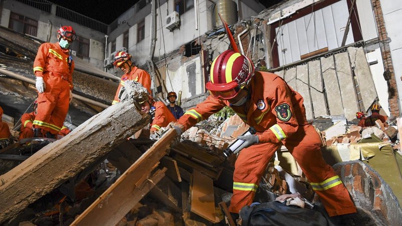 In this photo released by Xinhua News Agency, rescuers prepare equipment as they search for survivors at a collapsed hotel in Suzhou in eastern China's Jiangsu Province on Monday, July 12, 2021. The hotel building collapsed Monday afternoon. (Li Bo/Xinhua via AP)