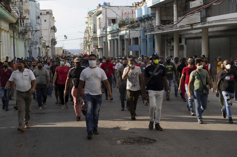 Cuba Protest Backers of the government march in Havana, Cuba, Sunday, July 11, 2021. Hundreds of supporters of the government took to the streets while hundreds more protested against ongoing food shortages and high prices of foodstuffs. (AP Photo/Eliana Aponte)