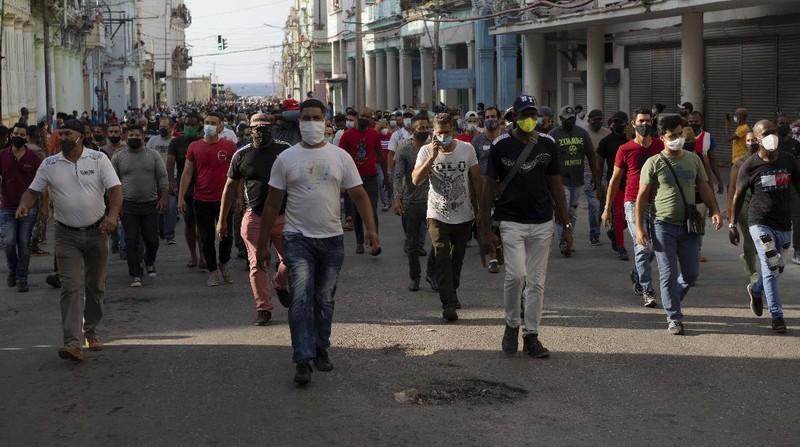 Backers of the government march in Havana, Cuba, Sunday, July 11, 2021. Hundreds of supporters of the government took to the streets while hundreds more protested against ongoing food shortages and high prices of foodstuffs. (AP Photo/Eliana Aponte)