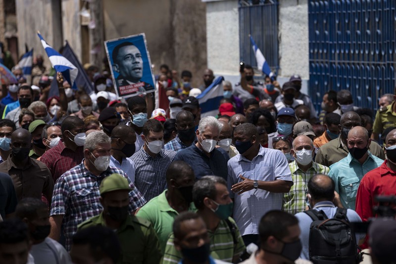 Backers of the government march in Havana, Cuba, Sunday, July 11, 2021. Hundreds of supporters of the government took to the streets while hundreds more protested against ongoing food shortages and high prices of foodstuffs. (AP Photo/Eliana Aponte)