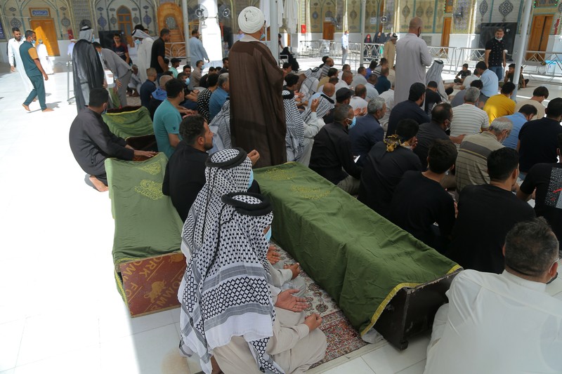 People gather outside a COVID-19 hospital in Nasiriyah, Iraq, early Tuesday, July 13, 2021. A catastrophic blaze erupted at the coronavirus hospital ward. It was the second time a large fire killed coronavirus patients in an Iraqi hospital this year. (AP Photo)
