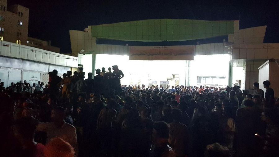 People gather outside a COVID-19 hospital in Nasiriyah, Iraq, early Tuesday, July 13, 2021. A catastrophic blaze erupted at the coronavirus hospital ward. It was the second time a large fire killed coronavirus patients in an Iraqi hospital this year. (AP Photo)
