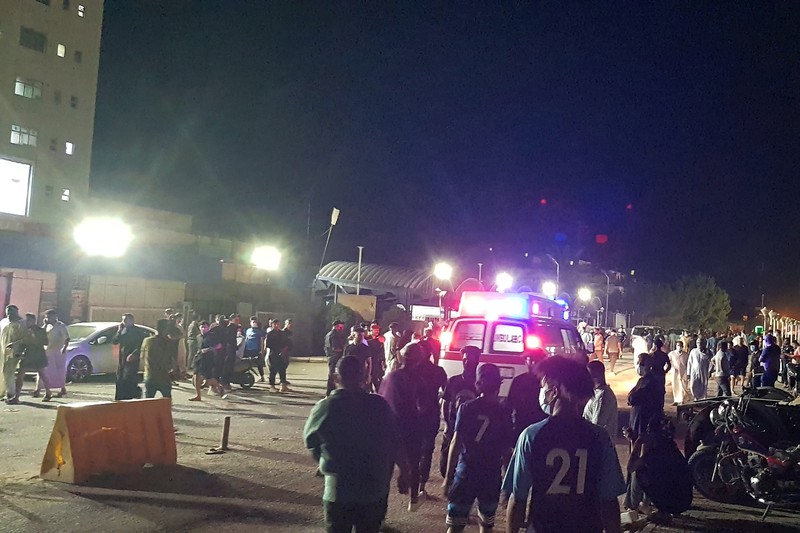 Iraq Hospital Fire People gather outside a COVID-19 hospital in Nasiriyah, Iraq, early Tuesday, July 13, 2021. A catastrophic blaze erupted at the coronavirus hospital ward. It was the second time a large fire killed coronavirus patients in an Iraqi hospital this year. (AP Photo)