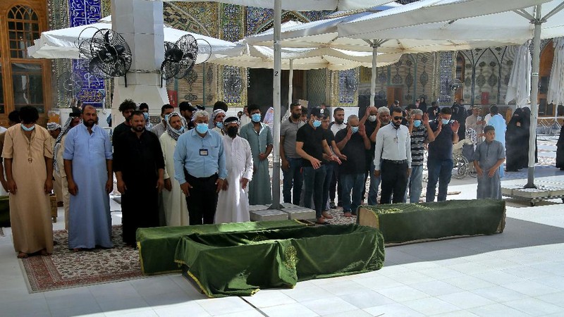 People gather outside a COVID-19 hospital in Nasiriyah, Iraq, early Tuesday, July 13, 2021. A catastrophic blaze erupted at the coronavirus hospital ward. It was the second time a large fire killed coronavirus patients in an Iraqi hospital this year. (AP Photo)