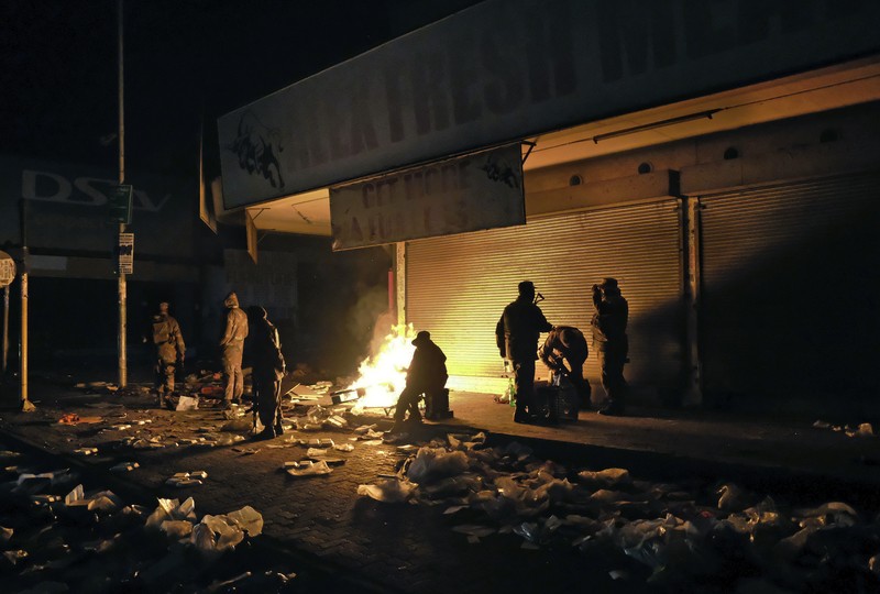 Kerusuhan di Afrika Selatan yang dipicu protes penahanan mantan presiden Yakub Zuma. Looters run as policer officers chassis at a shopping centre in Soweto, Johannesburg, Tuesd in Johannesburg, South Africa, Tuesday, July 13, 2021. South Africa's rioting continued Tuesday with the death toll rising to 32 as police and the military struggle to quell the violence in Gauteng and KwaZulu-Natal provinces. The violence started in various parts of KwaZulu-Natal last week when Zuma began serving a 15-month sentence for contempt of court. (AP Photo/Themba Hadebe)