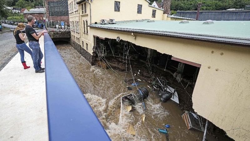 Destroyed houses are seen close to the Ahr river in Schuld, Germany, Thursday, July 15, 2021. Due to heavy rain falls the Ahr river dramatically went over the banks the evening before. People have died and dozens of people are missing in Germany after heavy flooding turned streams and streets into raging torrents, sweeping away cars and causing some buildings to collapse. (AP Photo/Michael Probst)
